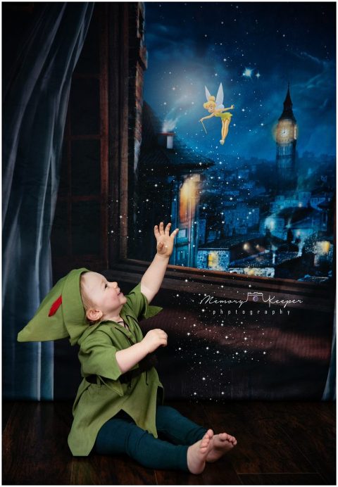 Boy dressed as Peter Pan with a "Never Grow UP" birthday theme. 